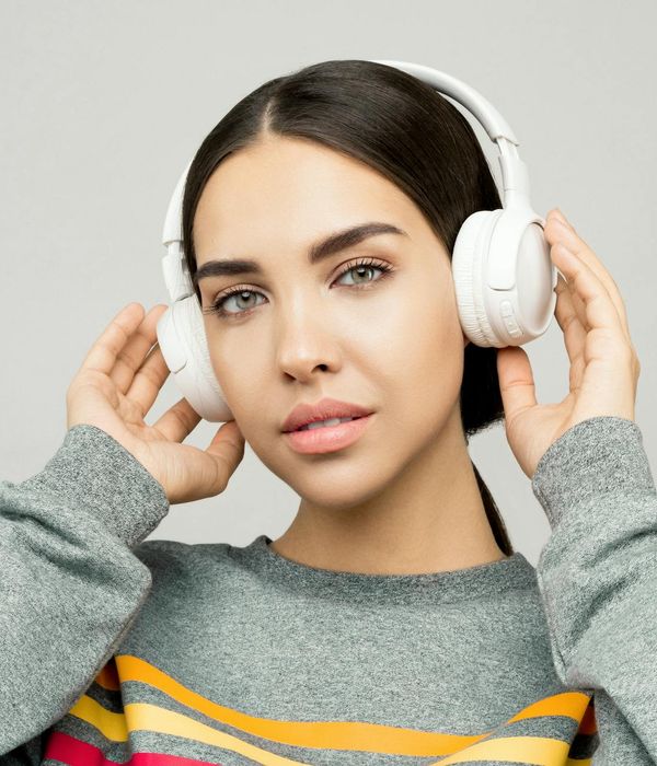 Woman in a dynamic cardio pose against a dark background.